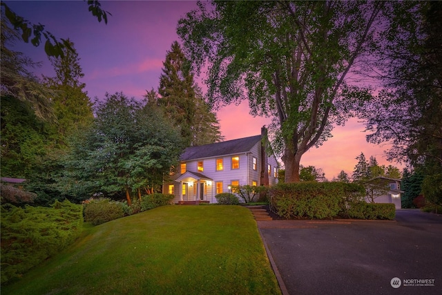 colonial inspired home featuring a lawn