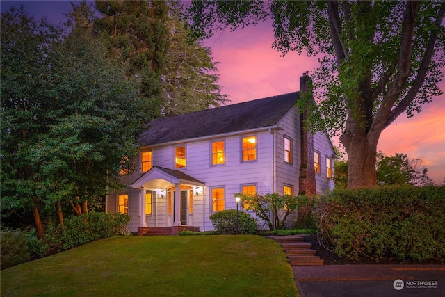 colonial house featuring a yard