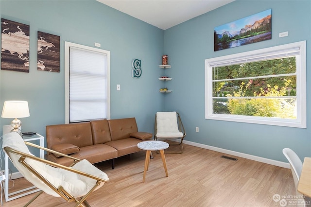 living area with light hardwood / wood-style flooring