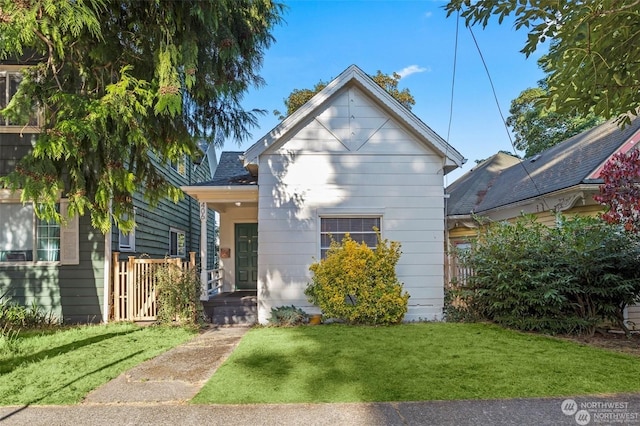 bungalow-style home with a front lawn