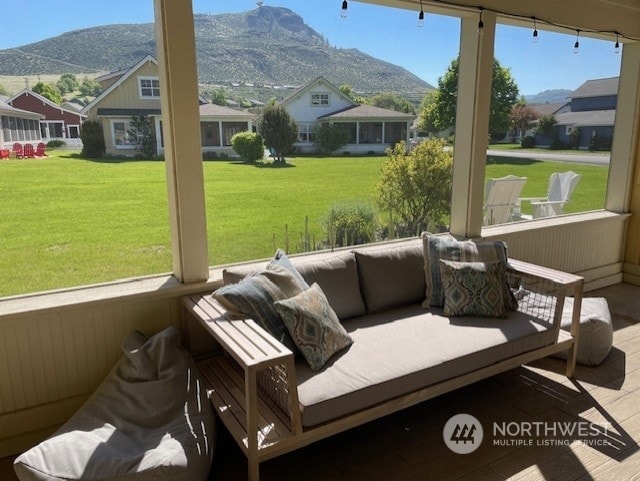 sunroom / solarium featuring a mountain view