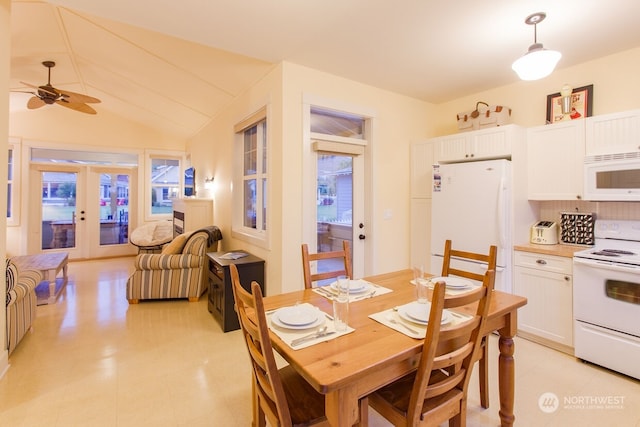 dining area featuring vaulted ceiling, french doors, and ceiling fan