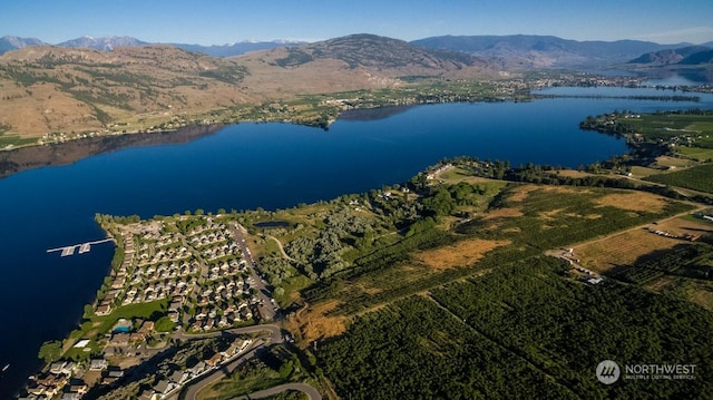 bird's eye view with a water and mountain view