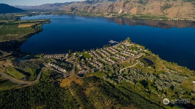 drone / aerial view featuring a water and mountain view