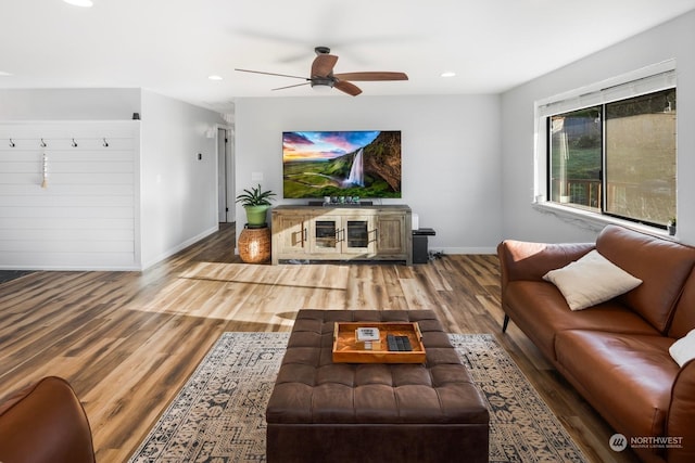 living room with hardwood / wood-style floors and ceiling fan