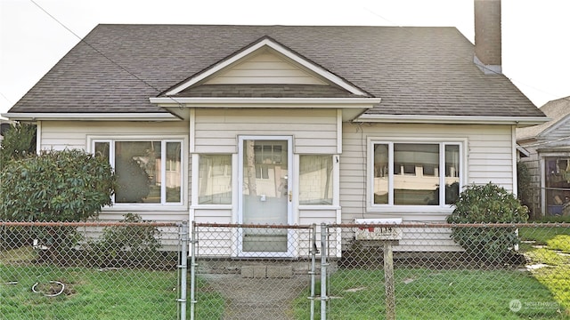 bungalow-style house featuring a shingled roof, a fenced front yard, a front yard, a chimney, and a gate