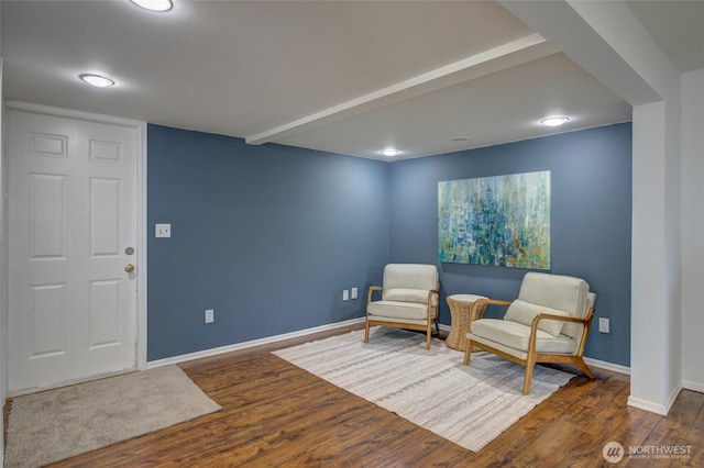 sitting room with baseboards and wood finished floors