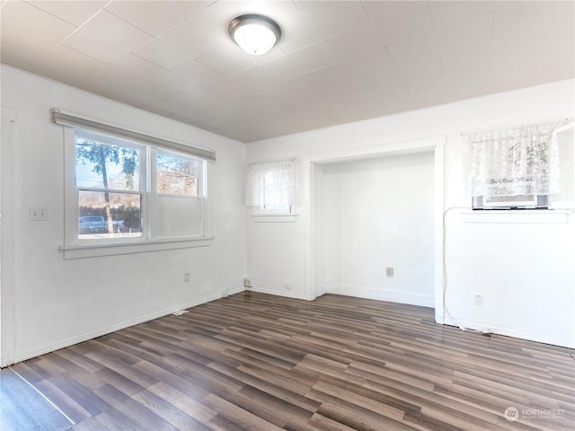 spare room featuring dark wood-type flooring