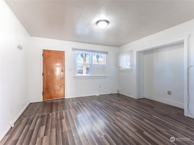 empty room with dark wood-type flooring