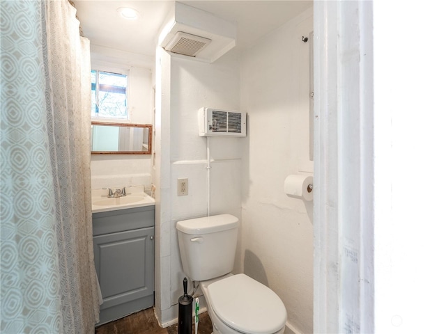 bathroom with hardwood / wood-style flooring, toilet, and vanity