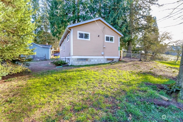 view of side of home with a yard