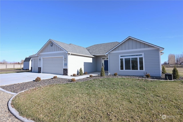 single story home with a garage and a front lawn