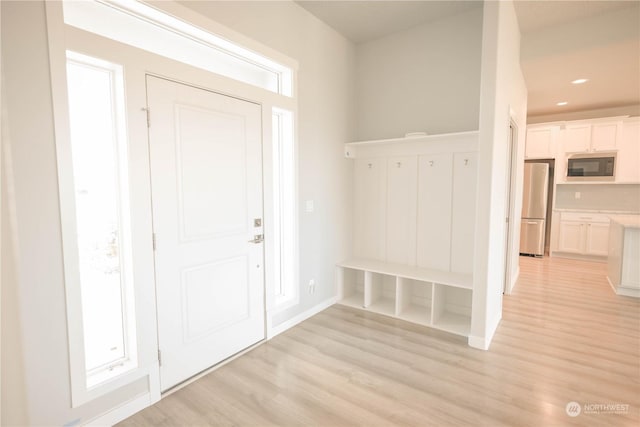 mudroom with light hardwood / wood-style flooring