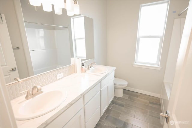 full bathroom featuring vanity, toilet, and washtub / shower combination