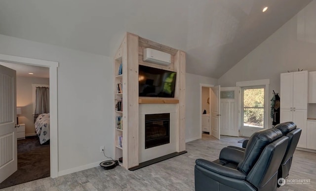 living room with high vaulted ceiling, light wood-type flooring, a fireplace, and a wall unit AC