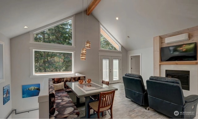 dining area featuring an AC wall unit, a fireplace, beam ceiling, high vaulted ceiling, and french doors