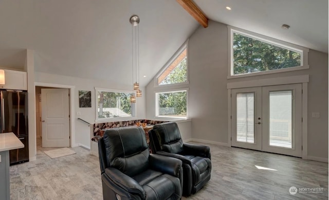 living room with beam ceiling, french doors, and high vaulted ceiling