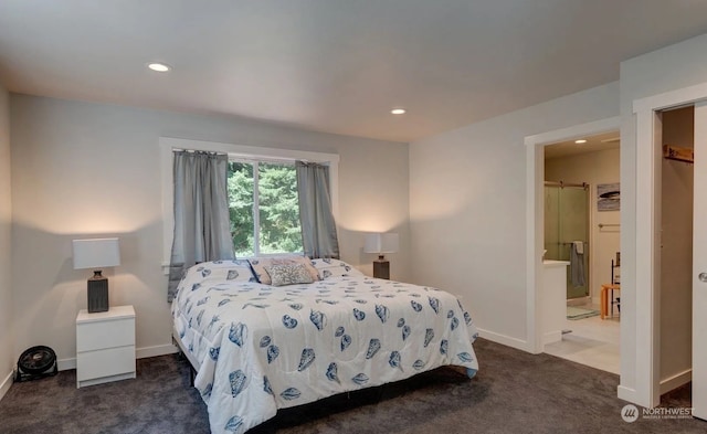 carpeted bedroom with ensuite bathroom and a barn door