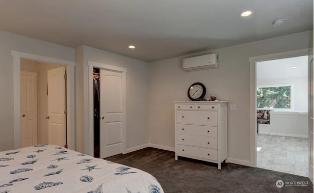 bedroom featuring a closet, a wall mounted AC, and dark colored carpet