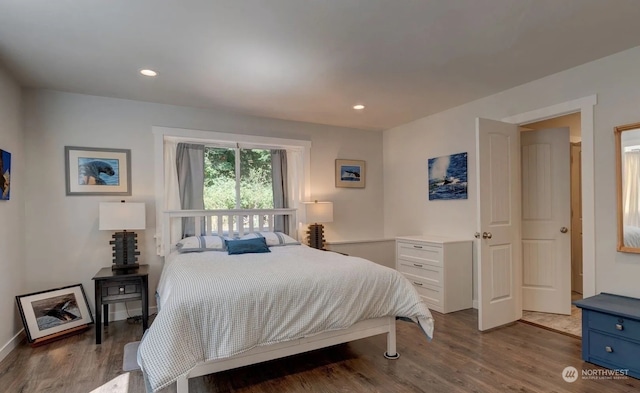 bedroom with dark wood-type flooring