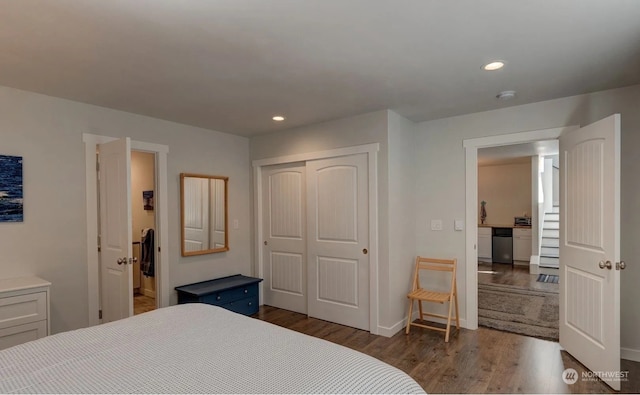 bedroom with a closet and dark hardwood / wood-style floors