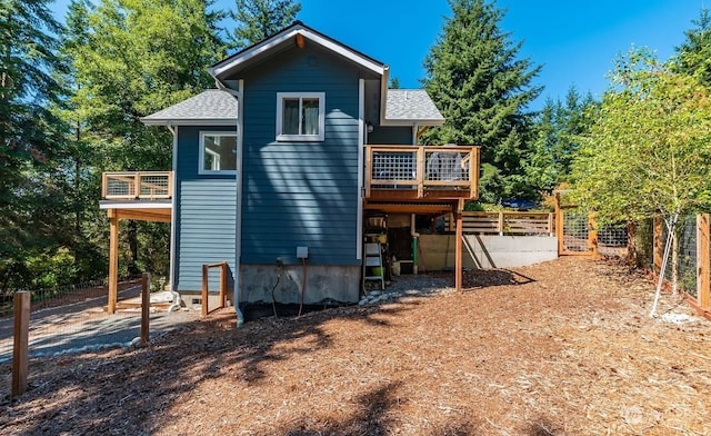 back of house featuring a wooden deck