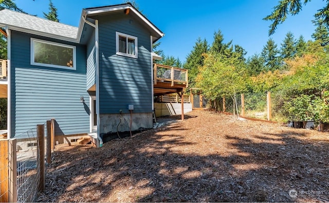 back of property featuring a deck