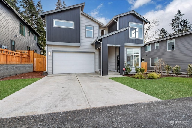 view of front facade with a garage and a front lawn