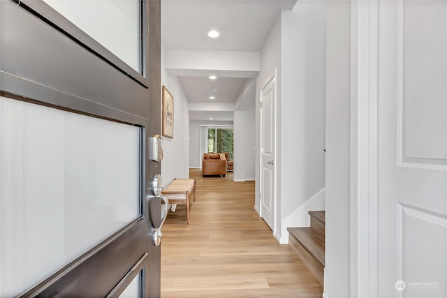 hallway with light hardwood / wood-style flooring