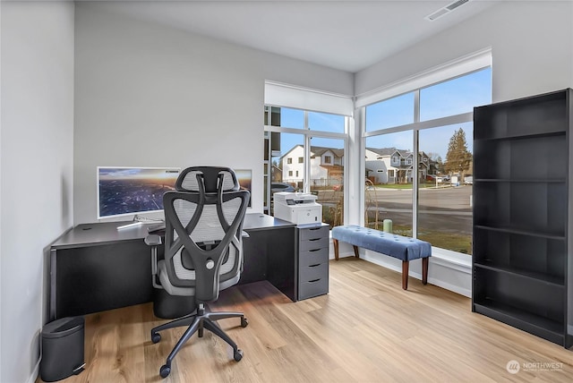 office area with light hardwood / wood-style floors