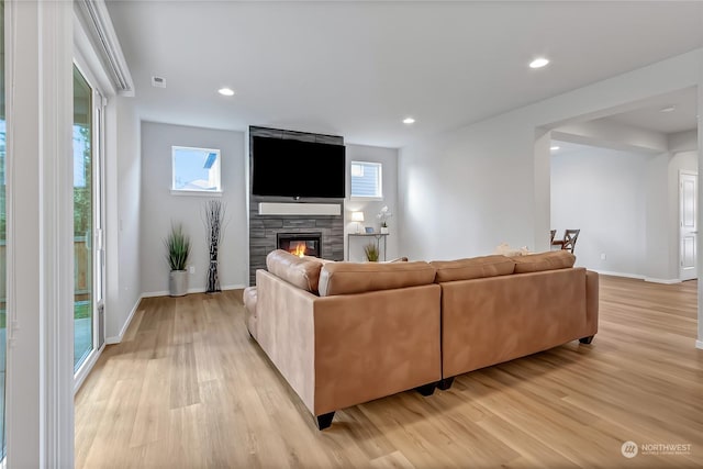 living room with light hardwood / wood-style floors and a fireplace