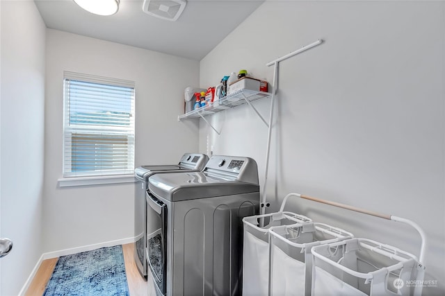 washroom featuring hardwood / wood-style floors and washer and clothes dryer