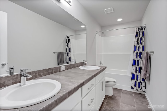 full bathroom with tile patterned floors, toilet, vanity, and shower / bathtub combination with curtain