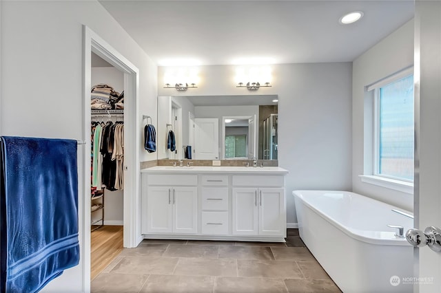 bathroom featuring vanity, tile patterned floors, and plus walk in shower