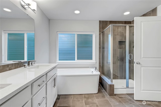 bathroom with vanity and separate shower and tub