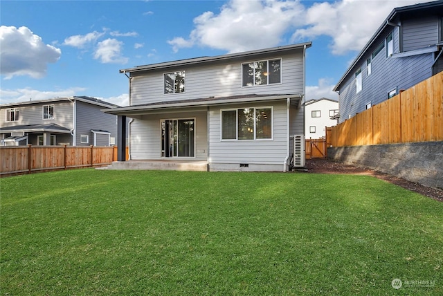 rear view of property featuring a patio and a lawn