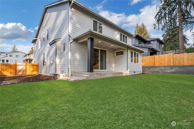 rear view of property featuring a yard