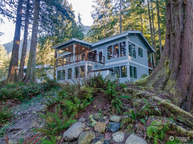 rear view of property featuring a balcony