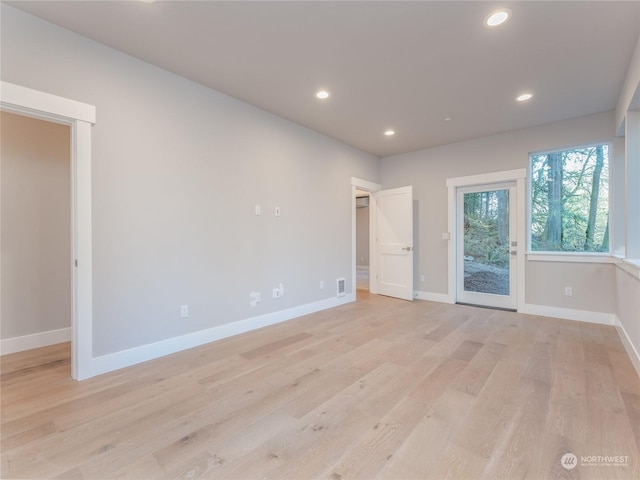 spare room featuring light hardwood / wood-style floors