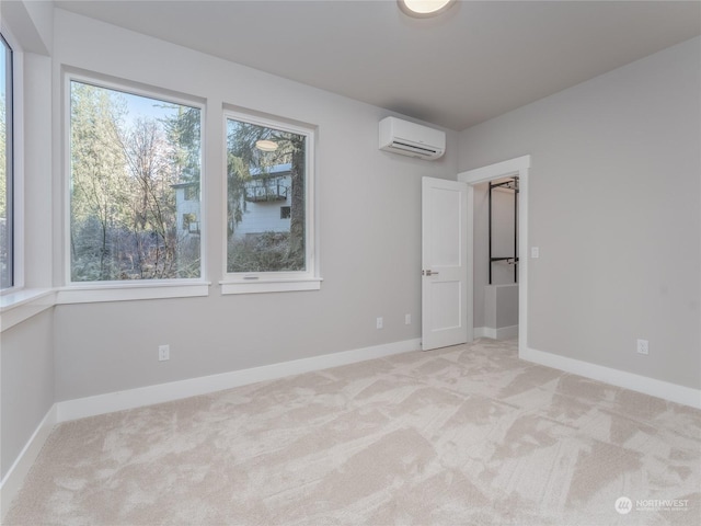 empty room with an AC wall unit and light carpet