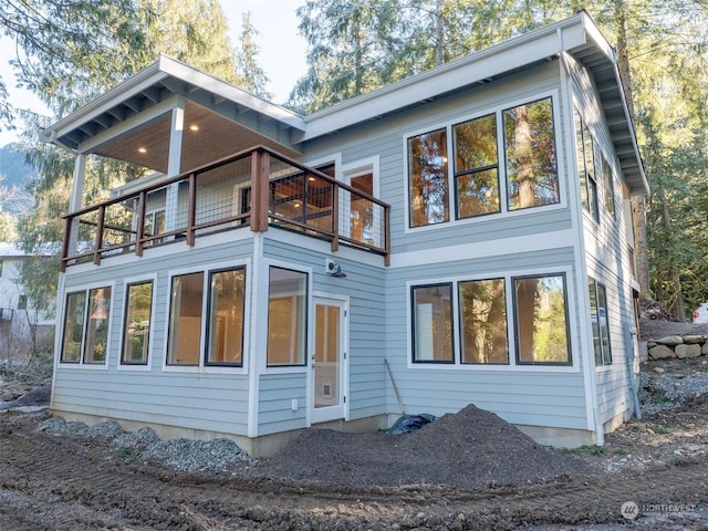 back of property with a balcony