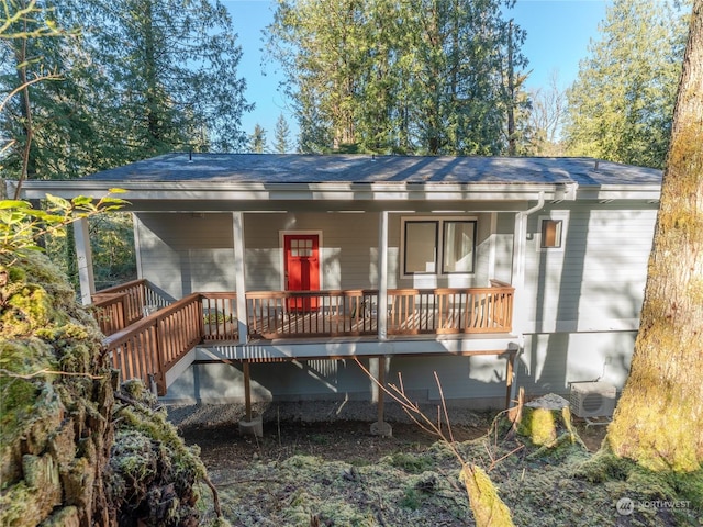 back of property with a wooden deck