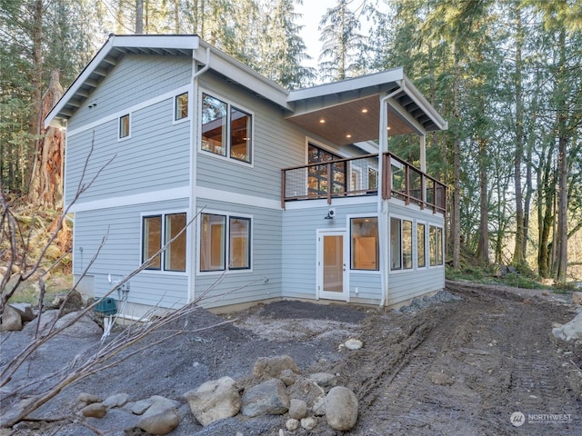 back of property with a balcony