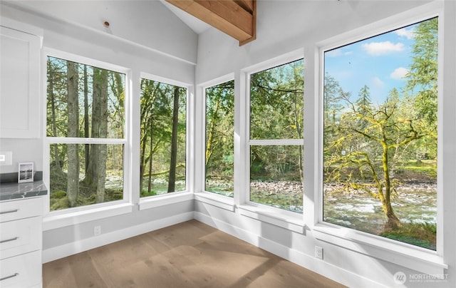 7339 Moon Valley Rd SE, North Bend, WA 98045 - unfurnished sunroom with baseboards, wood finished floors, and vaulted ceiling with beams
