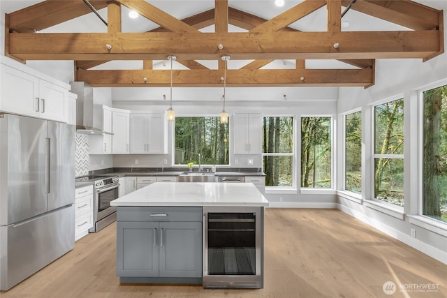 7339 Moon Valley Rd SE, North Bend, WA 98045 - kitchen featuring gray cabinetry, wall chimney range hood, wine cooler, appliances with stainless steel finishes, and white cabinetry