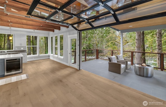 7339 Moon Valley Rd SE, North Bend, WA 98045 - unfurnished sunroom with baseboards, wine cooler, and wood finished floors