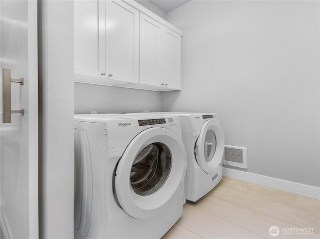 7339 Moon Valley Rd SE, North Bend, WA 98045 - washroom featuring washing machine and dryer, cabinet space, visible vents, and baseboards