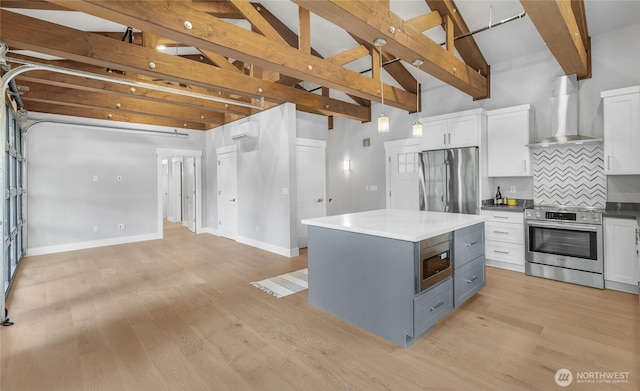 7339 Moon Valley Rd SE, North Bend, WA 98045 - kitchen featuring tasteful backsplash, white cabinetry, a wall unit AC, stainless steel appliances, and wall chimney range hood