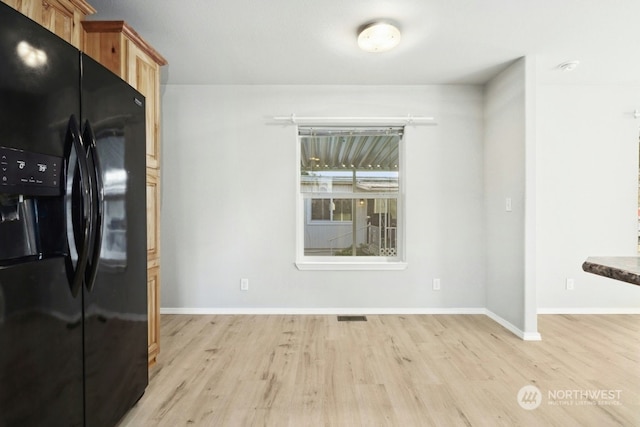 unfurnished dining area featuring light hardwood / wood-style flooring