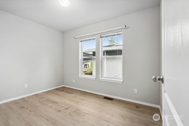 spare room with light hardwood / wood-style floors